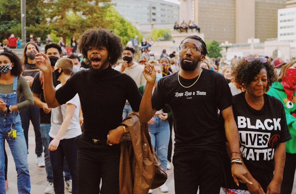 man in black crew neck t-shirt standing beside man in black crew neck t-shirt