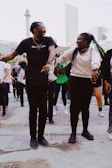 man in black crew neck t-shirt standing beside woman in white long sleeve shirt
