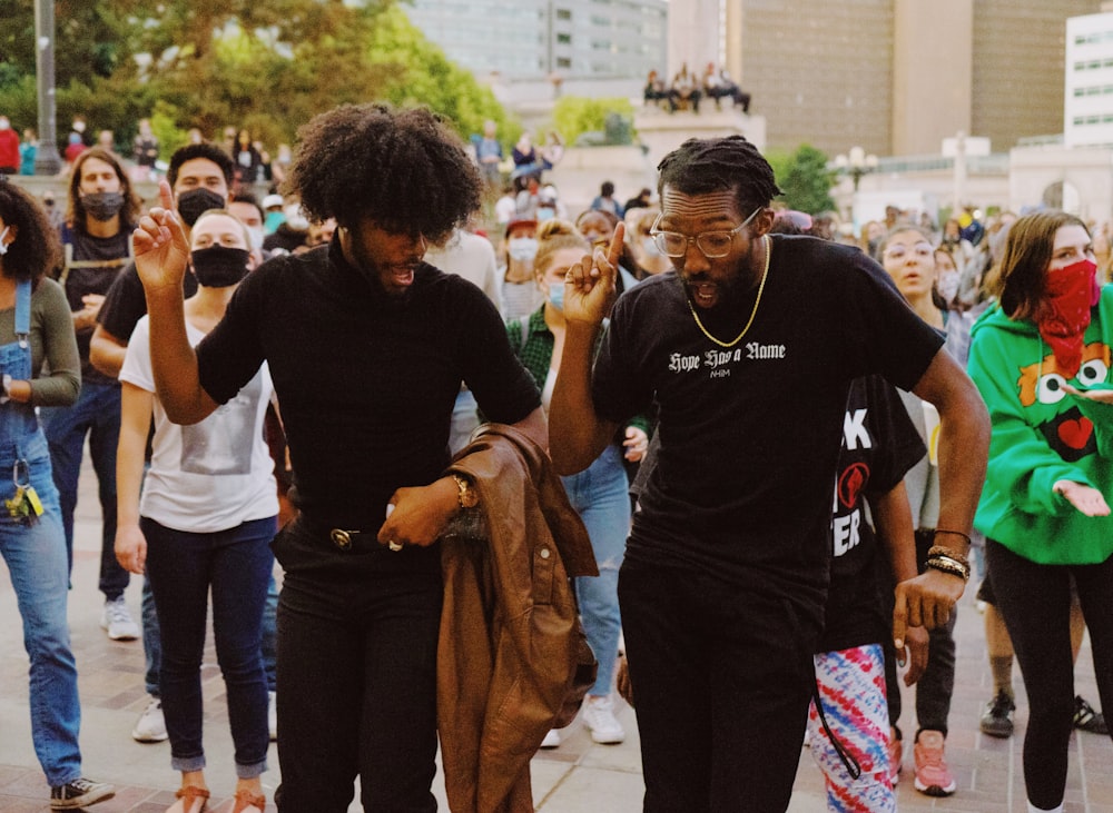 man in black crew neck t-shirt standing beside man in black t-shirt