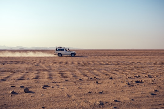 white suv on brown sand during daytime