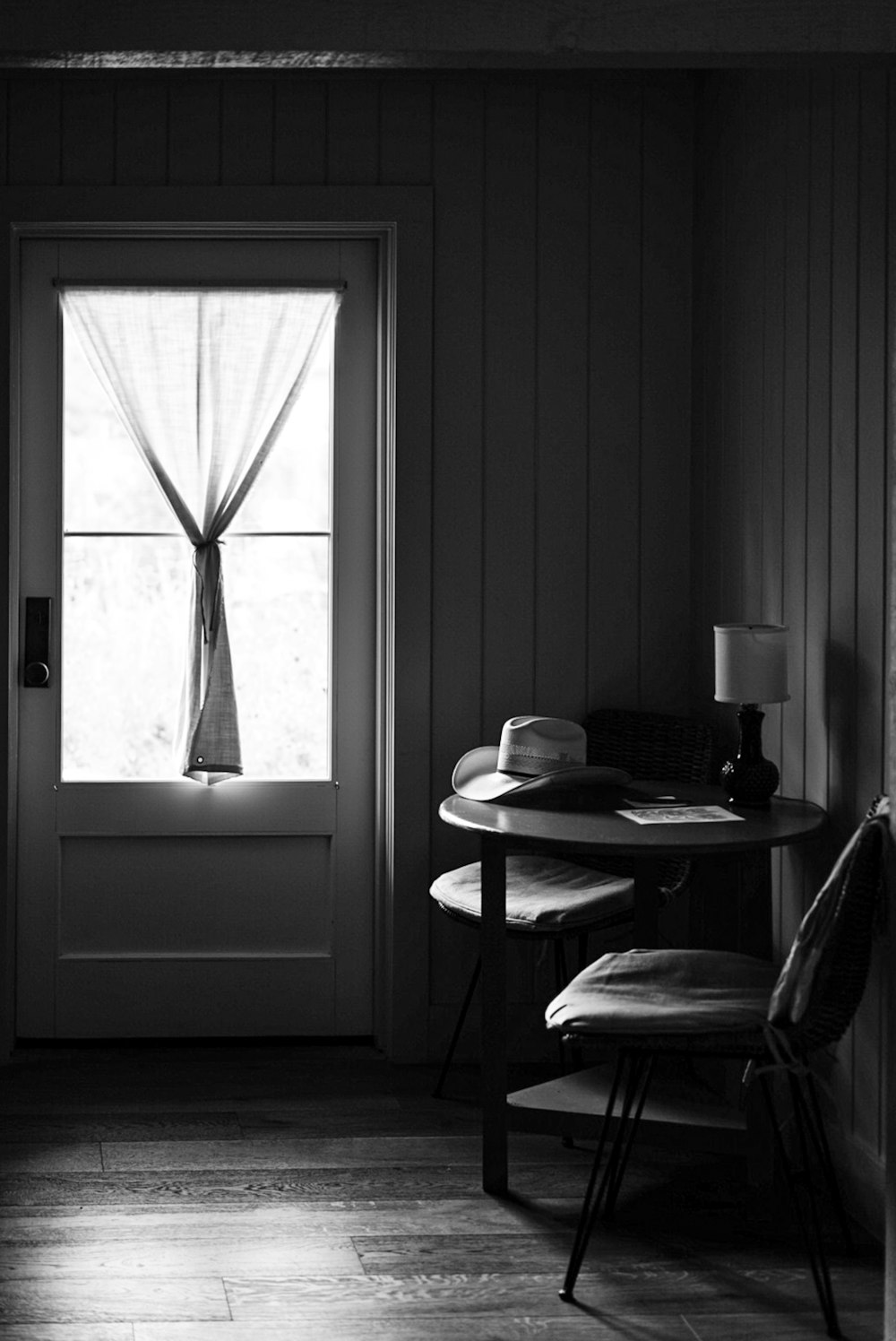 grayscale photo of table and chairs