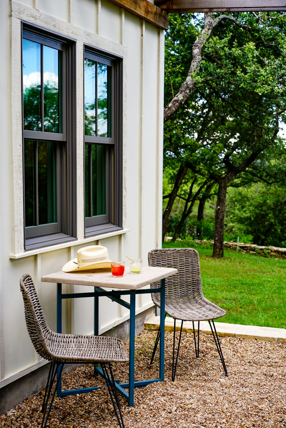 black metal table and chairs near green tree during daytime