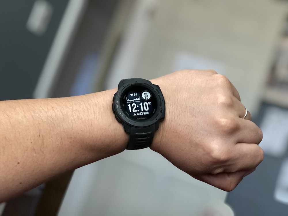 person wearing black digital watch