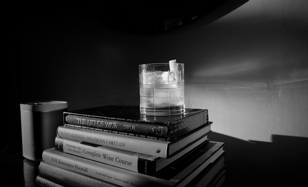 grayscale photo of books on table