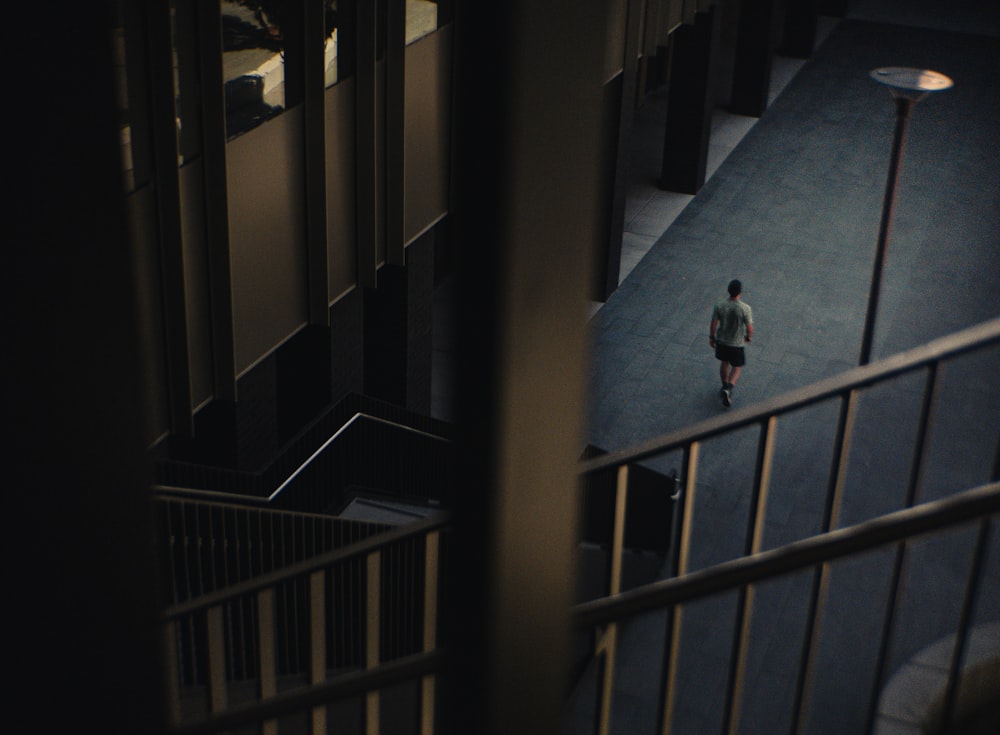 person in blue shirt walking on hallway