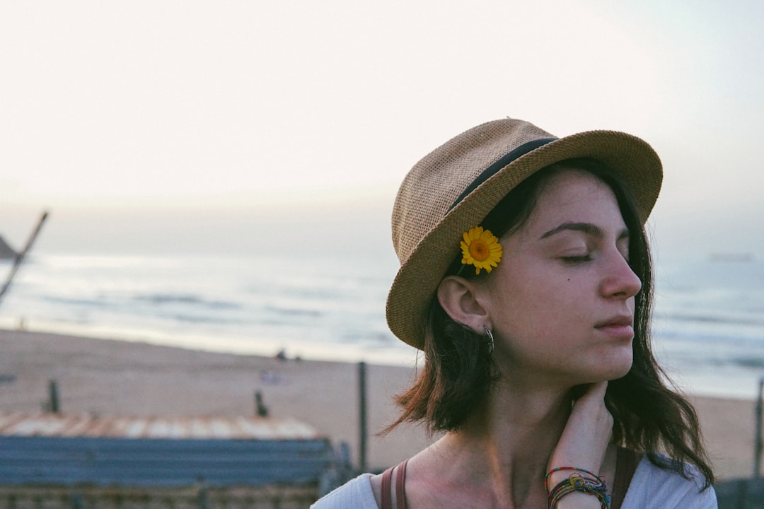 woman in white shirt wearing brown hat