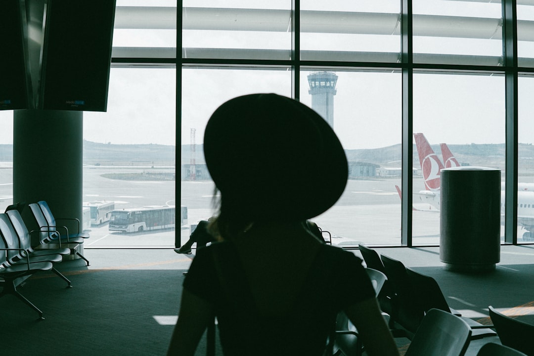 person in black jacket wearing black hat,