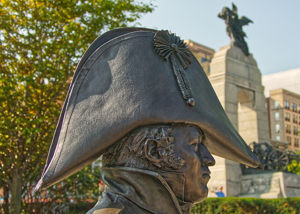 man with black hat statue