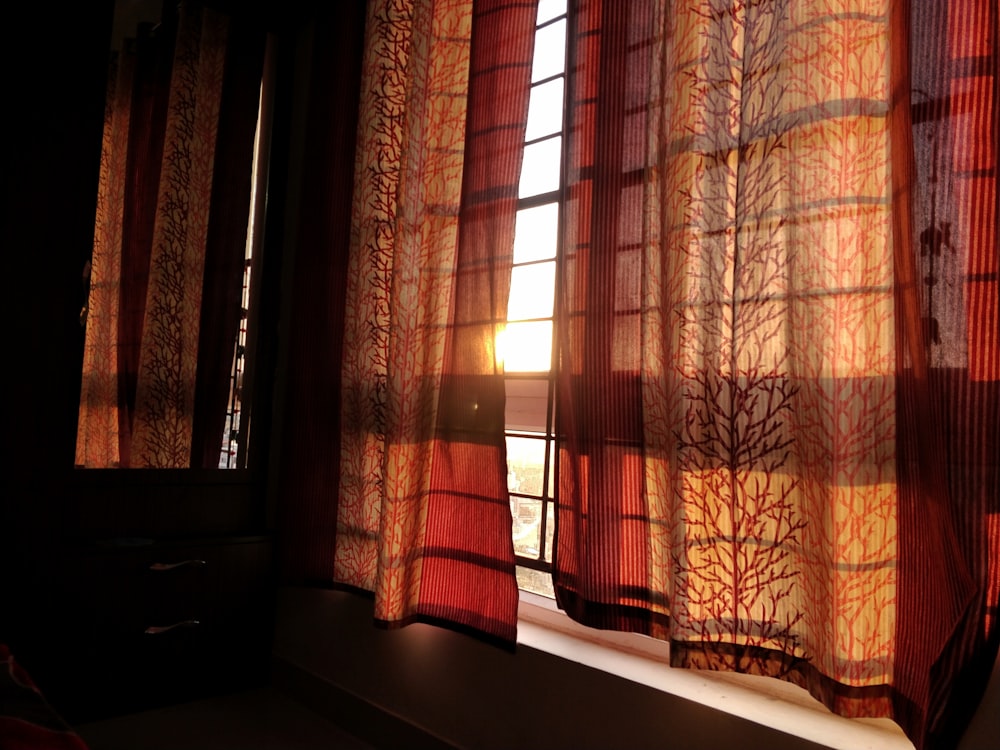brown and beige window curtain