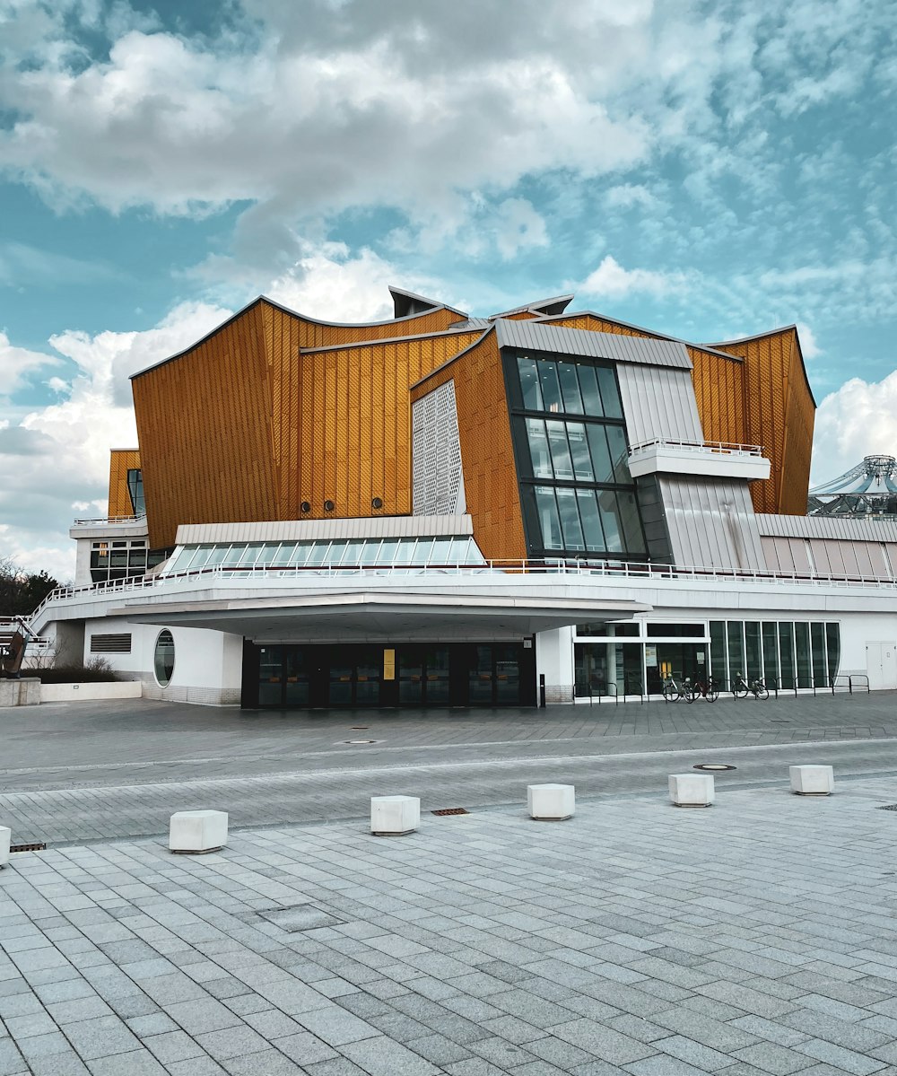 brown and white concrete building under white clouds during daytime