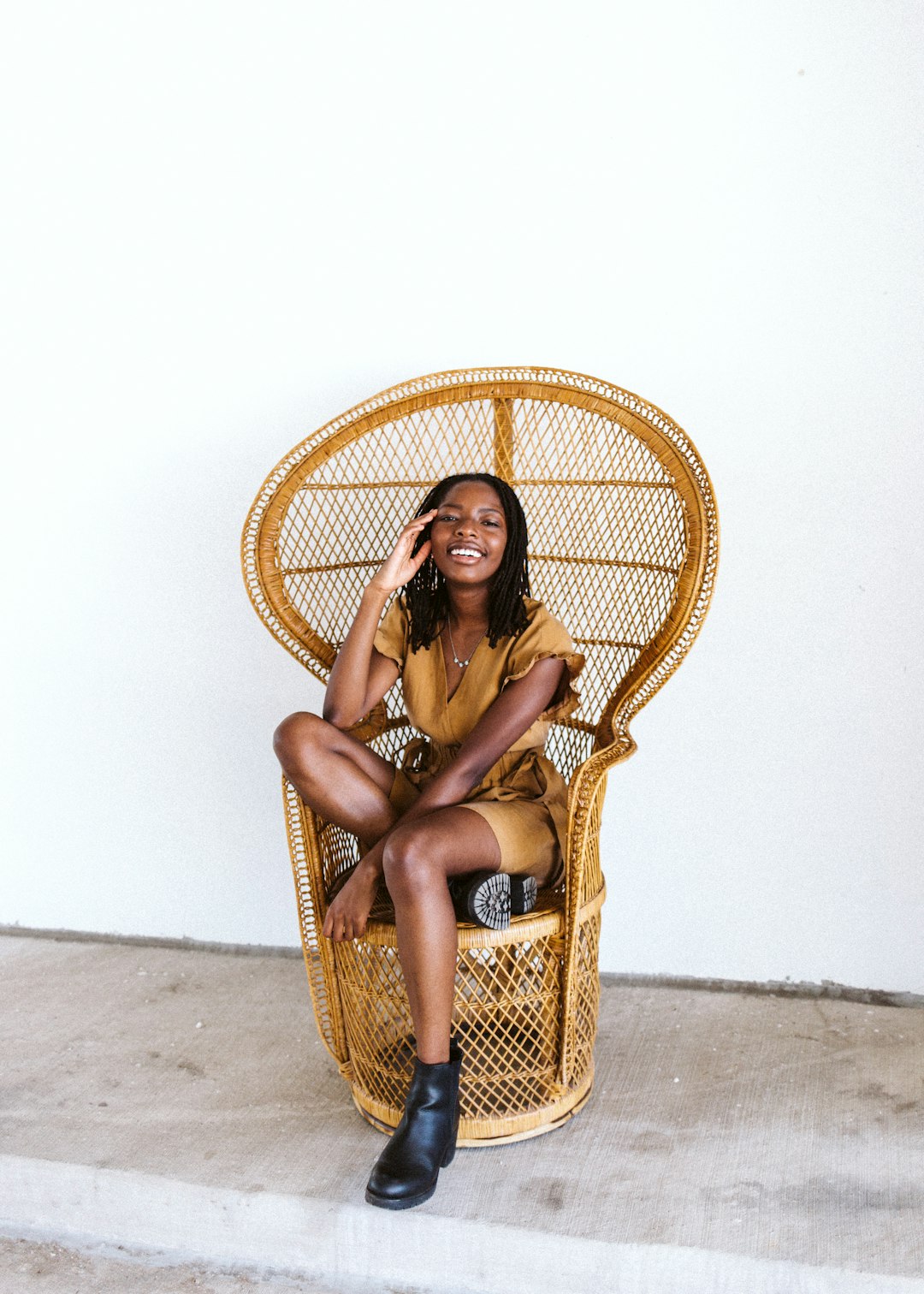 woman in brown woven hat sitting on brown woven chair