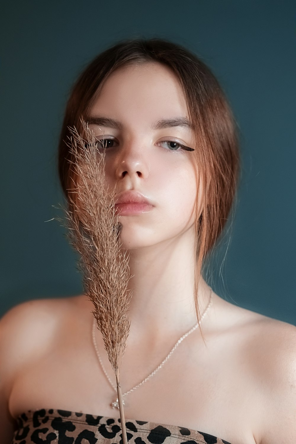 woman with brown hair and silver necklace