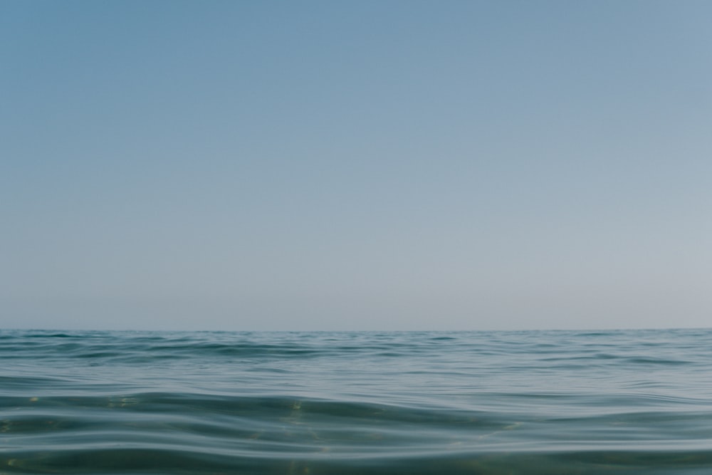 blue ocean water under blue sky during daytime