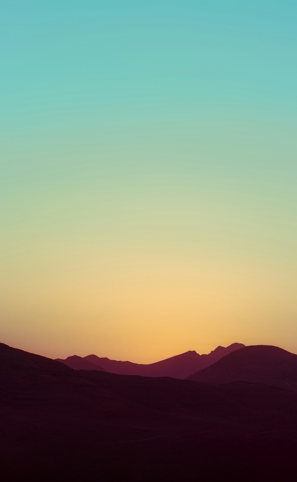 silhouette of mountains during sunset