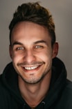 man in black hoodie smiling