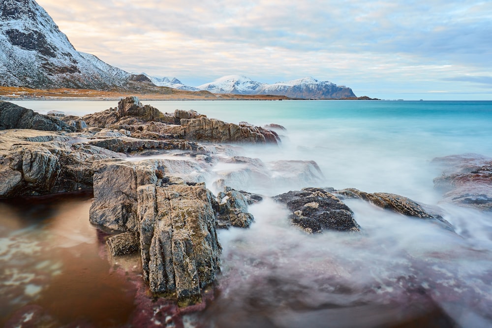 brown rock formation on sea during daytime