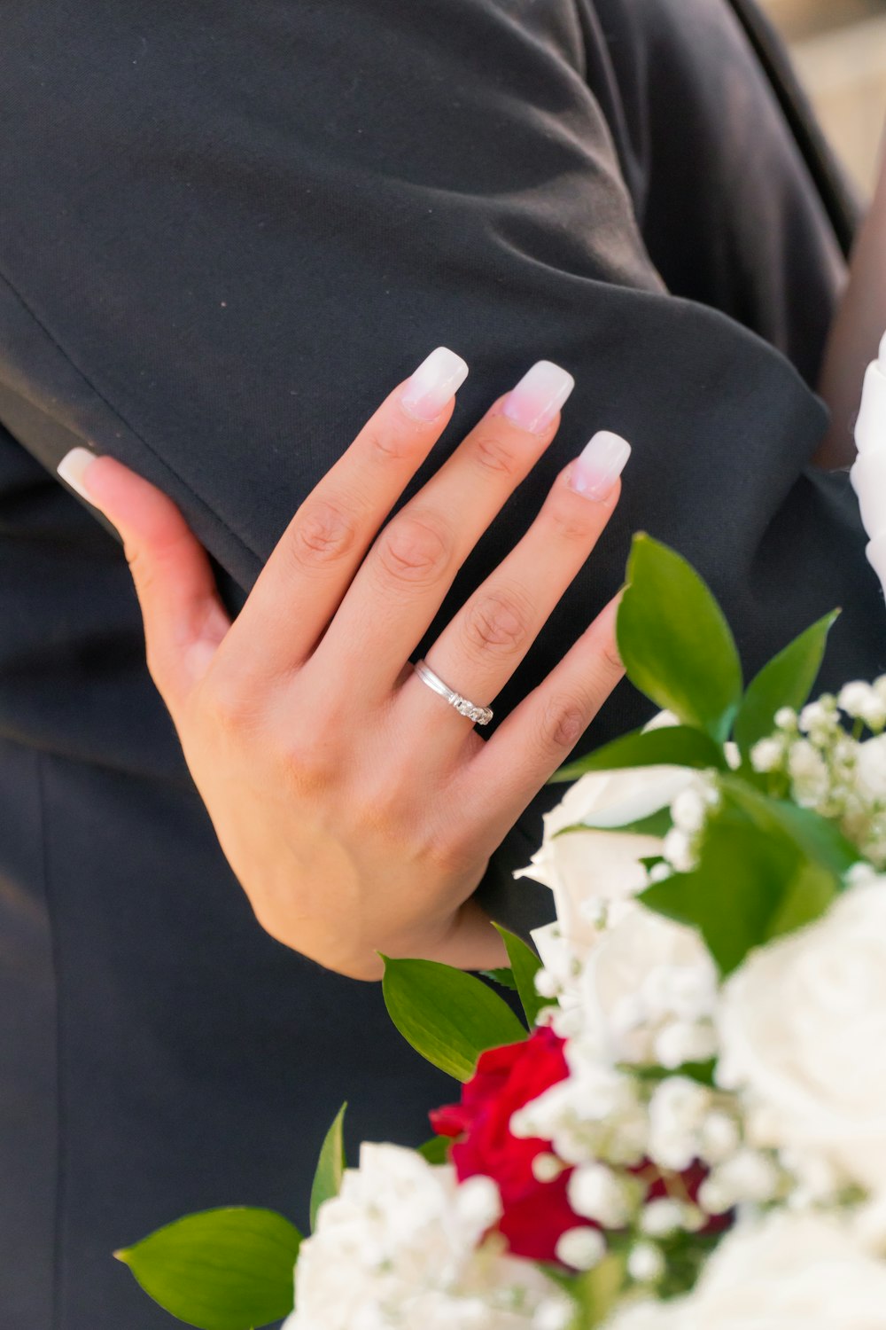 person wearing silver ring and ring