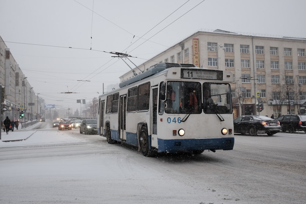 blue and white tram on road during daytime