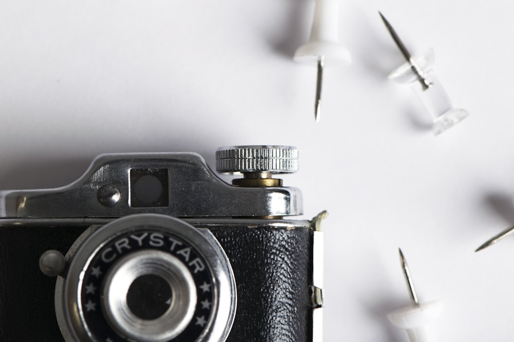 black and silver camera on white surface