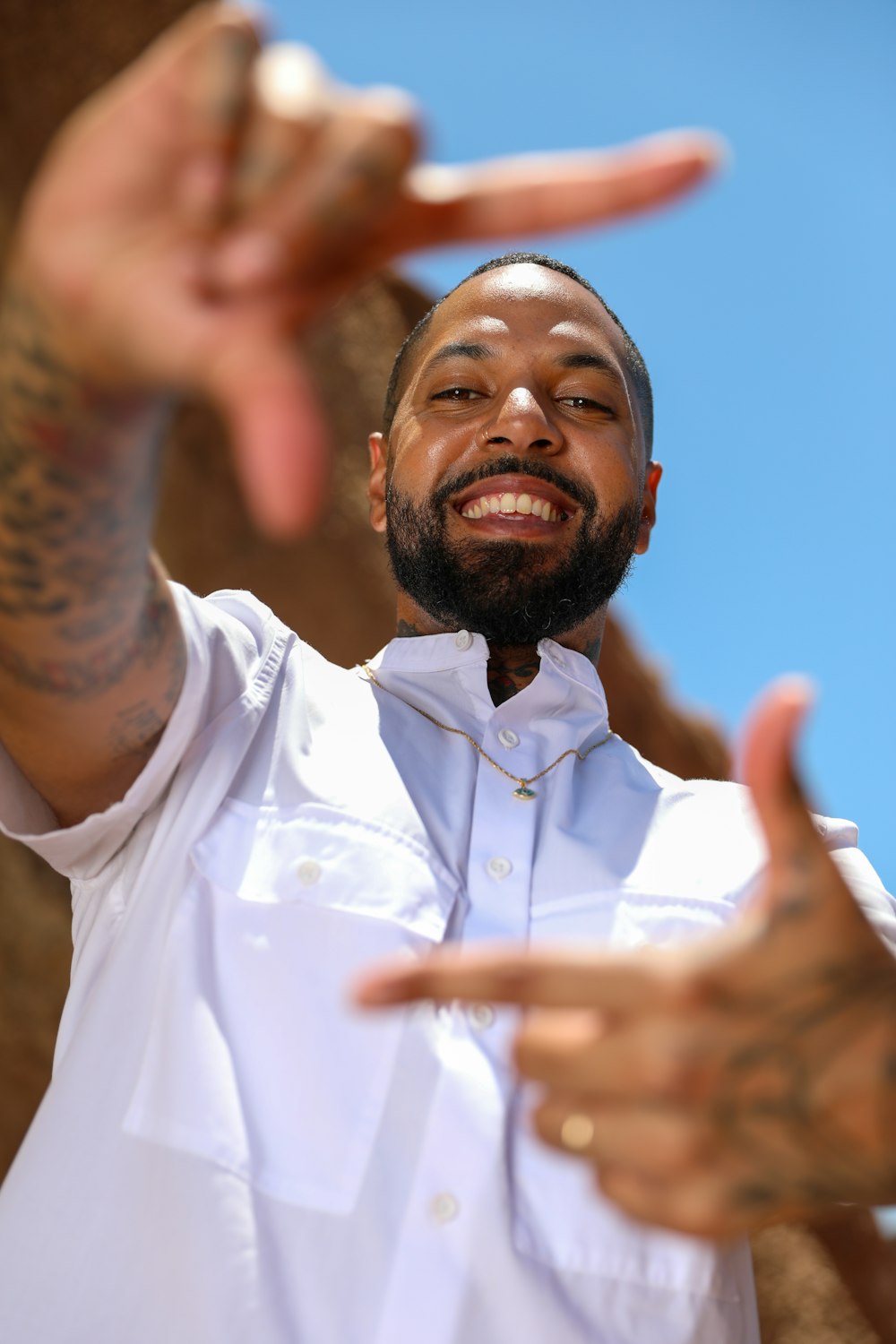 man in white dress shirt with arm tattoos