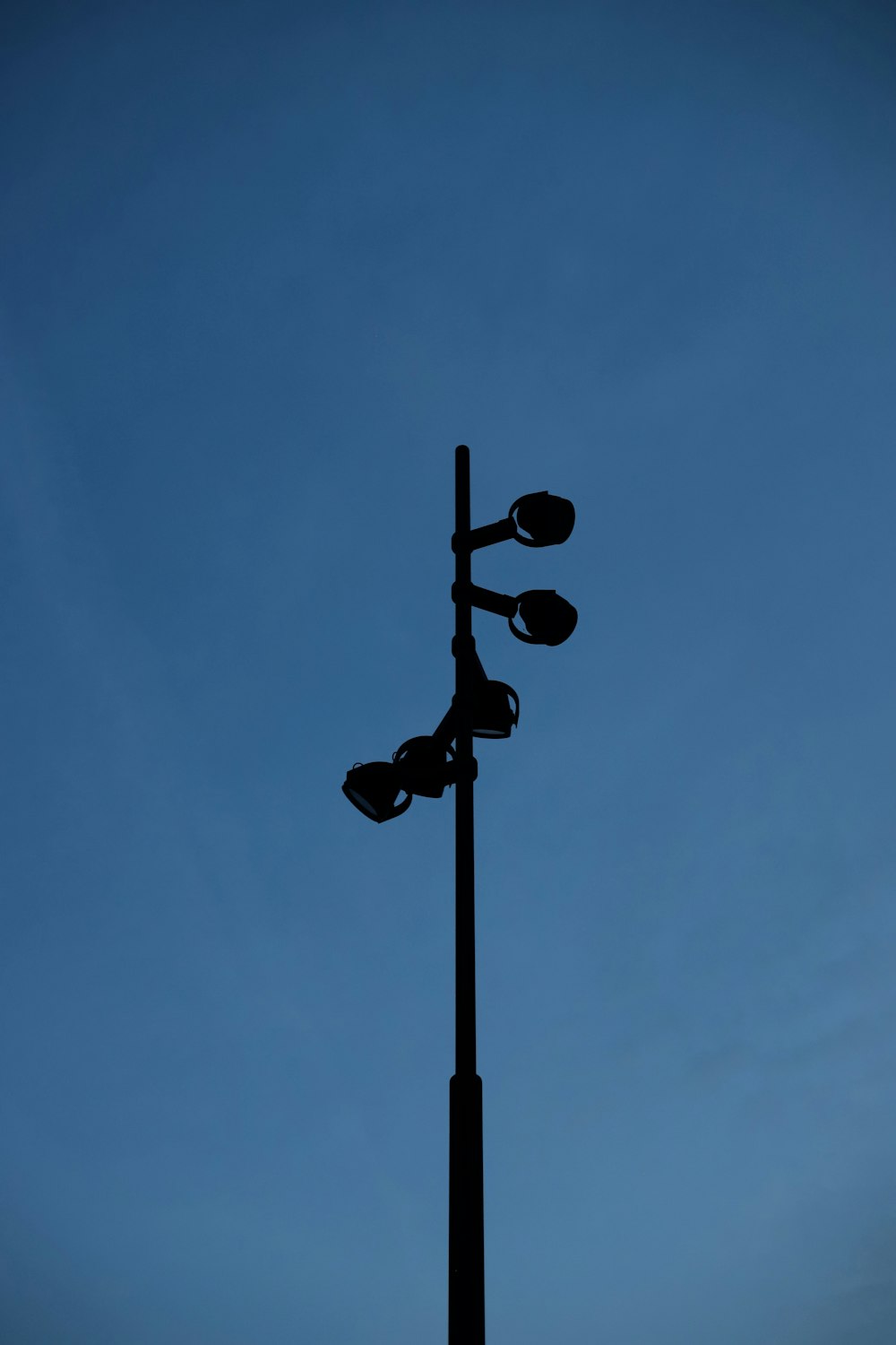 black street light under blue sky