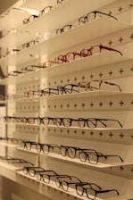 Display of various colorful eyewear cases arranged neatly on a white surface.