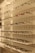 Shelves display various styles and colors of eyeglasses arranged neatly in rows against a white background with perforated holes.
