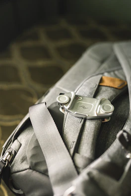 A close-up of premium packing cubes neatly arranged inside a warm brown leather backpack.