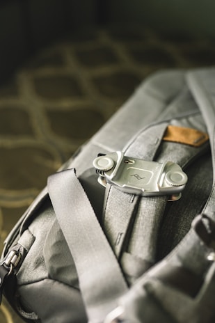 A close-up of a sleek, durable backpack resting on a city bench with morning light highlighting its texture.