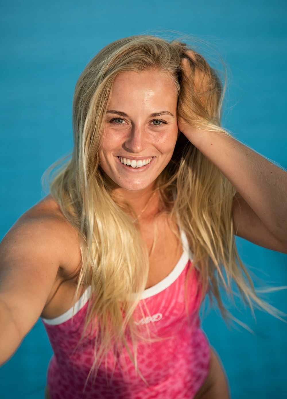 smiling woman in pink tank top