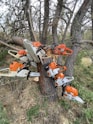 orange and white snow blower on brown tree