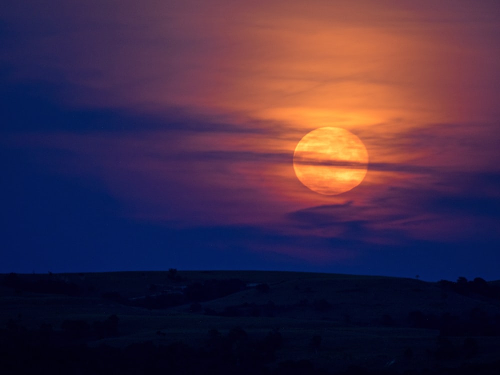 full moon over the mountains