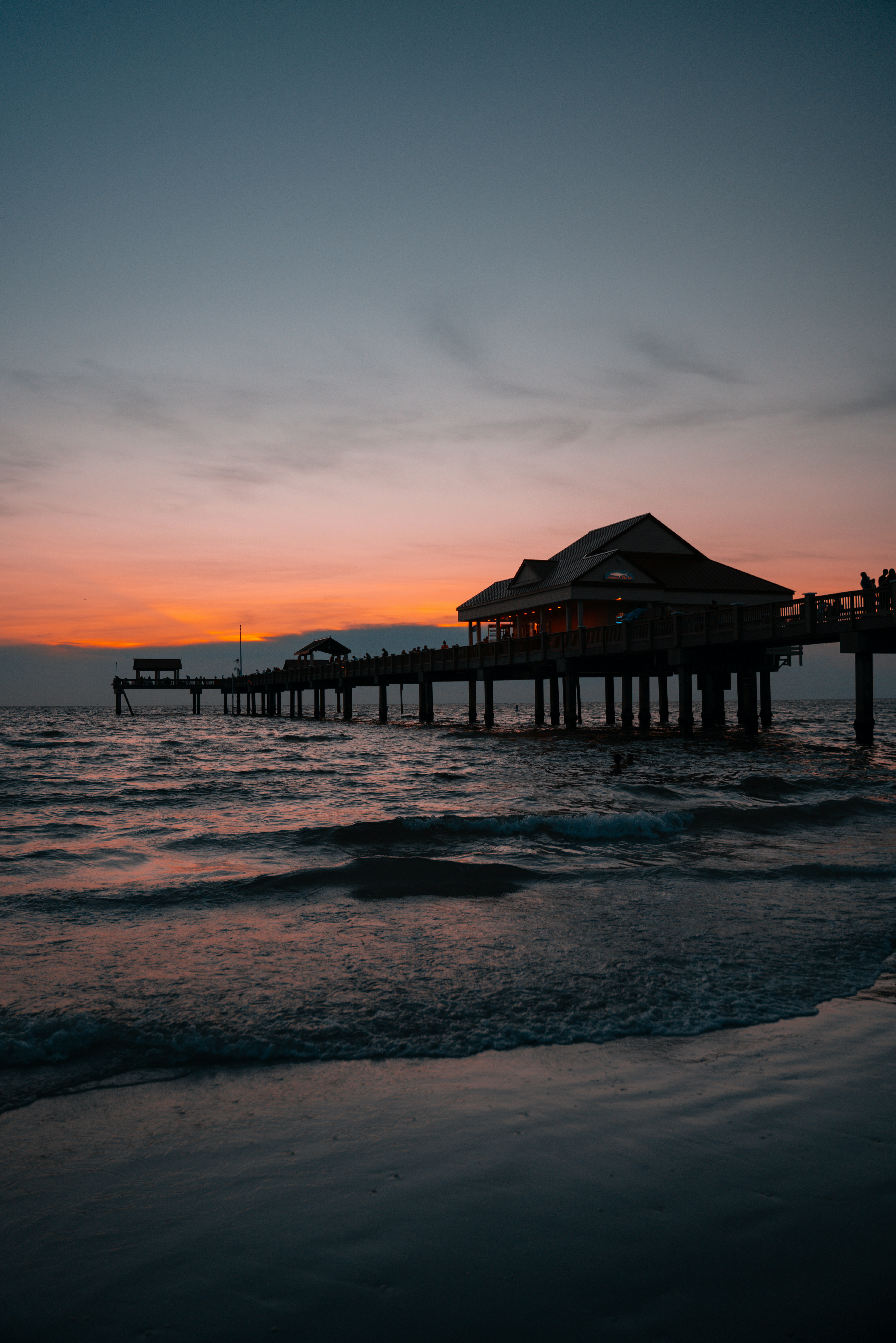 brown wooden dock on sea during sunset