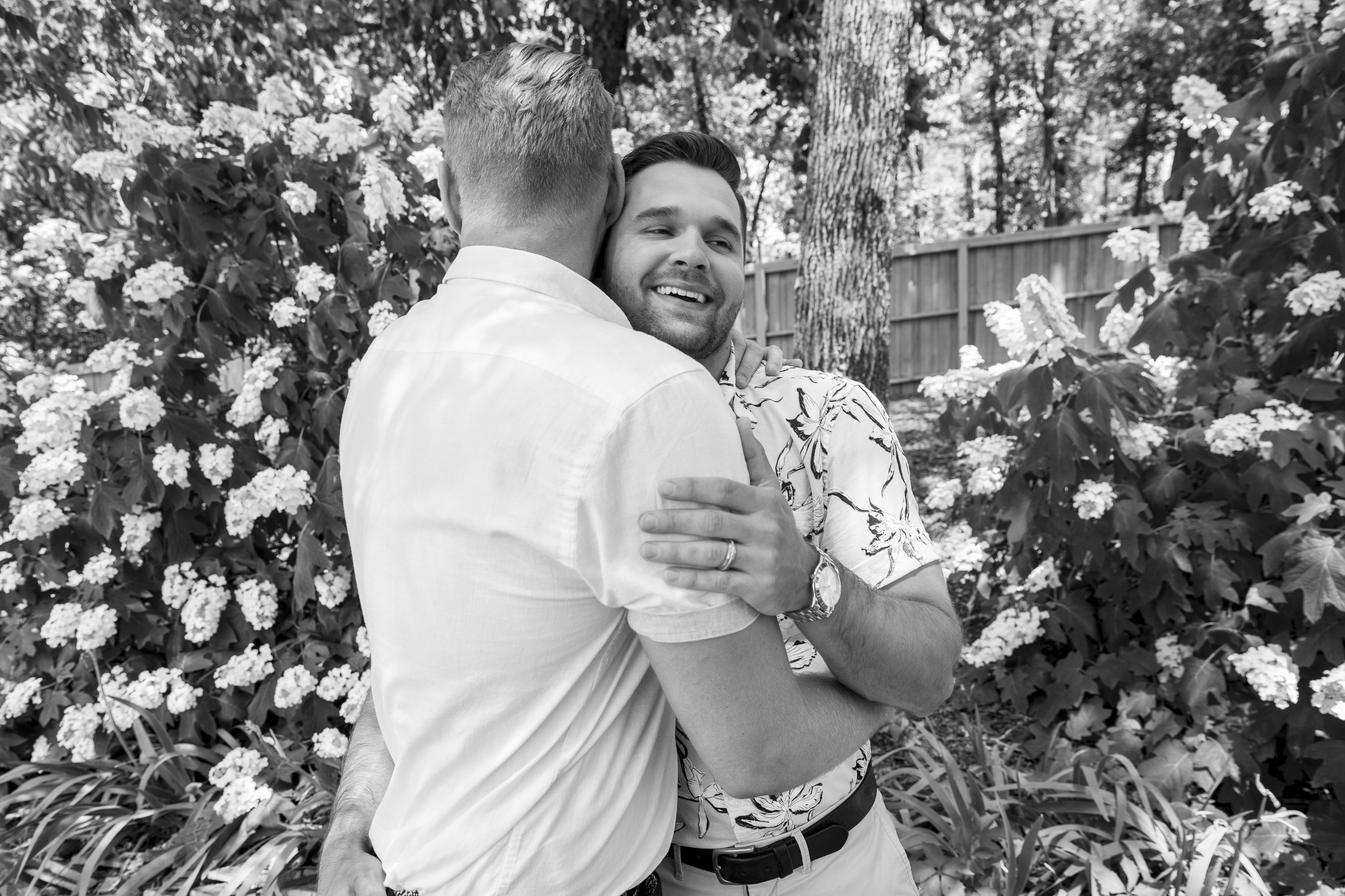 man in white shirt hugging woman in white shirt