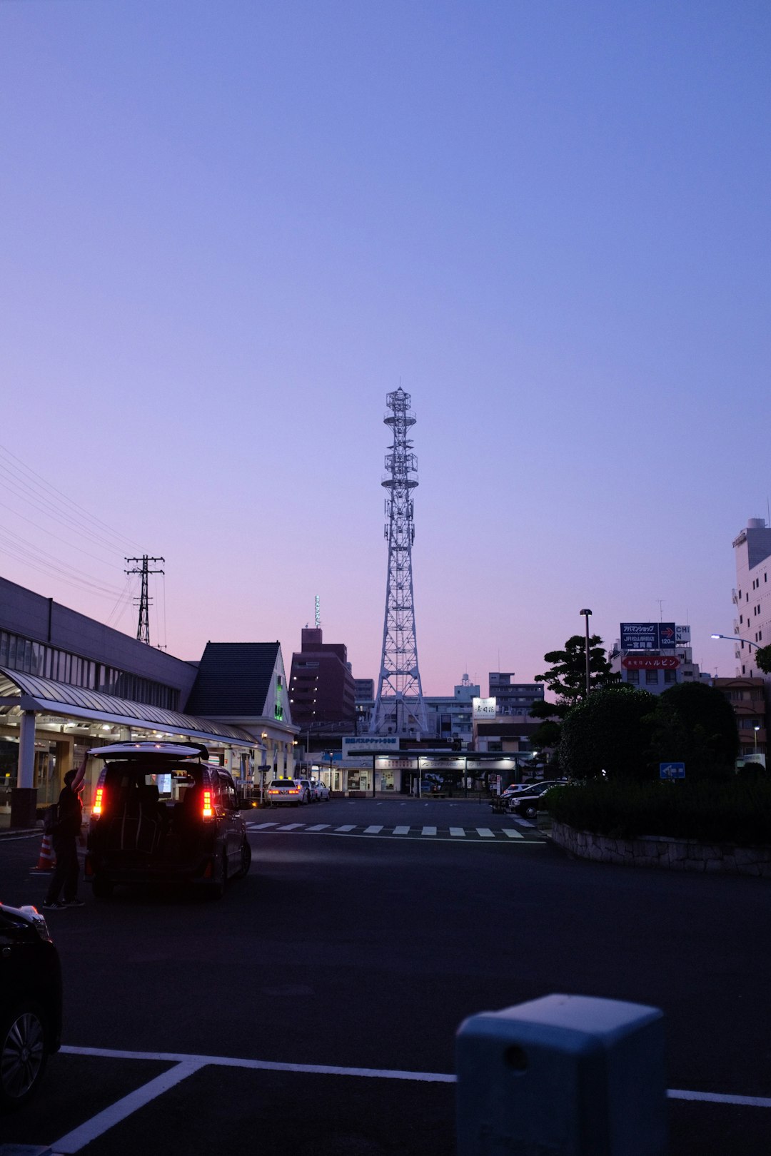 cars on road near tower during daytime