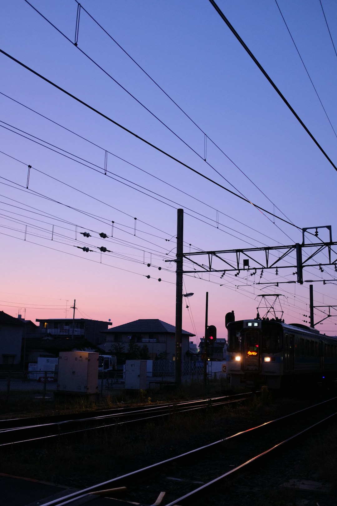 black and yellow train on rail tracks during daytime