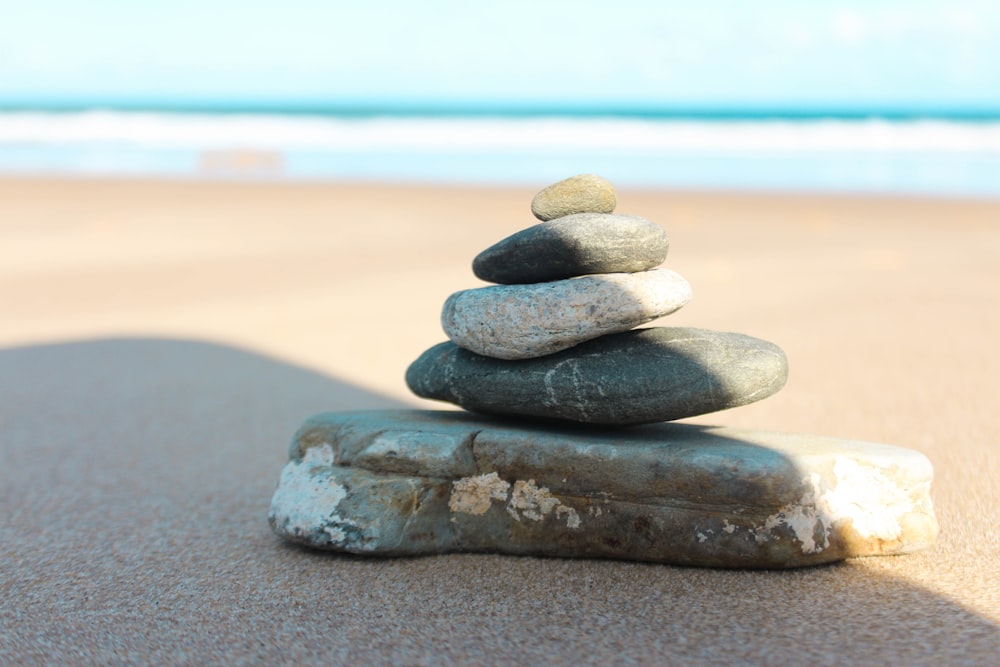 gray and black stone on beach during daytime