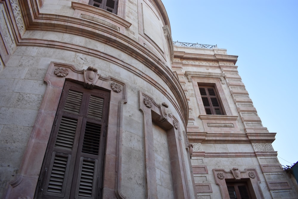 low angle photography of beige concrete building