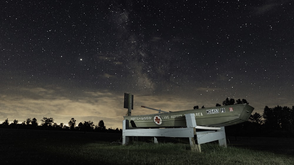 white wooden cross on green grass field during night time