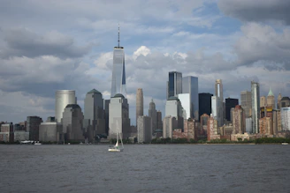 white boat on water near city buildings during daytime