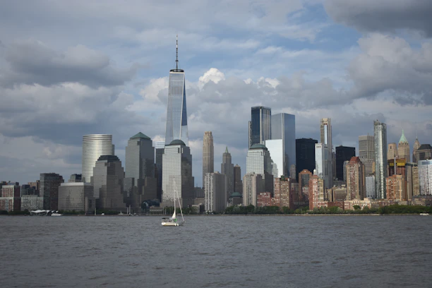 white boat on water near city buildings during daytime