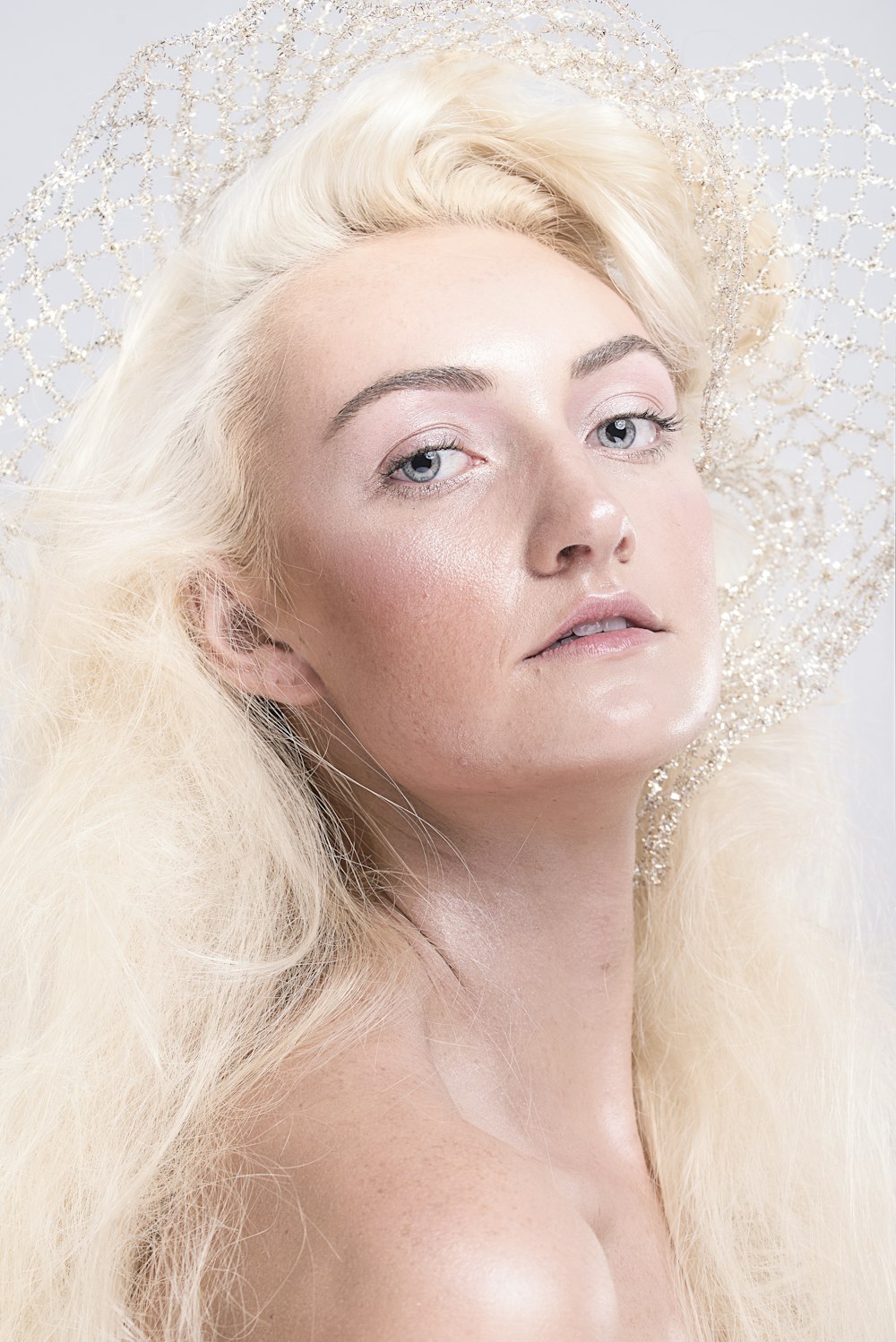 woman with blonde hair and white pearl earrings