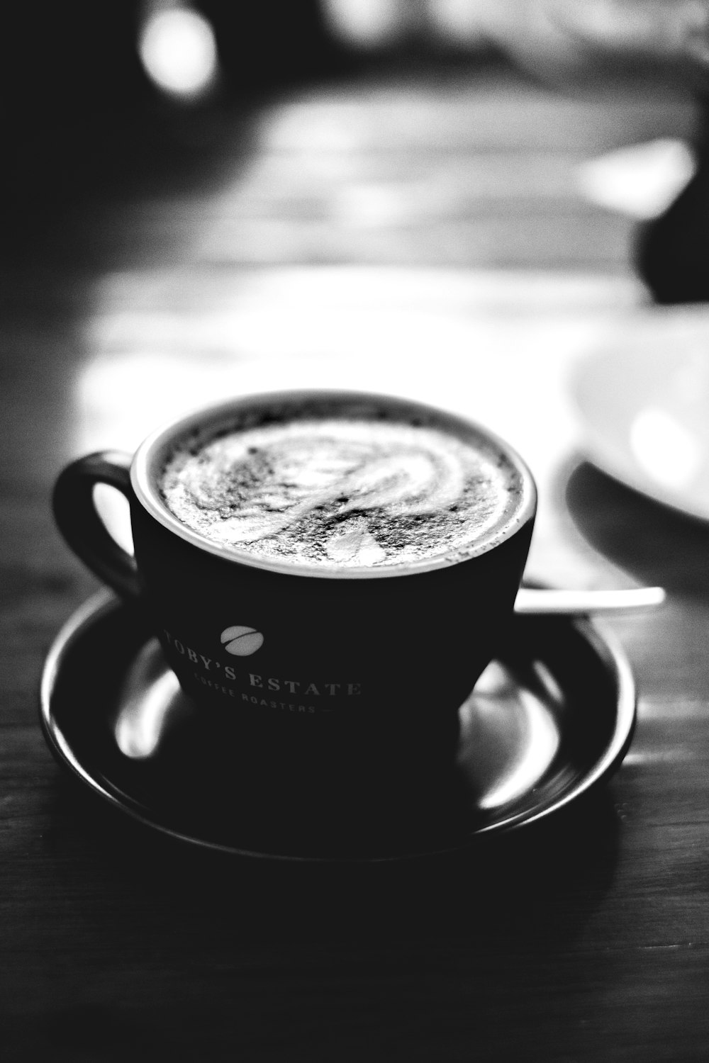 black and white ceramic cup with saucer