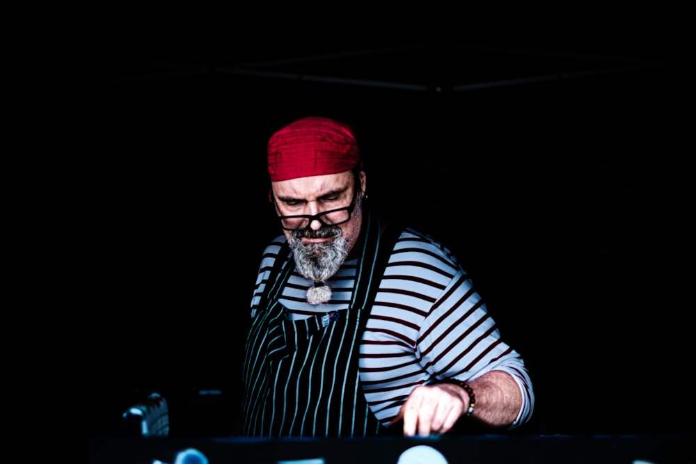 man in red knit cap and black and white striped long sleeve shirt