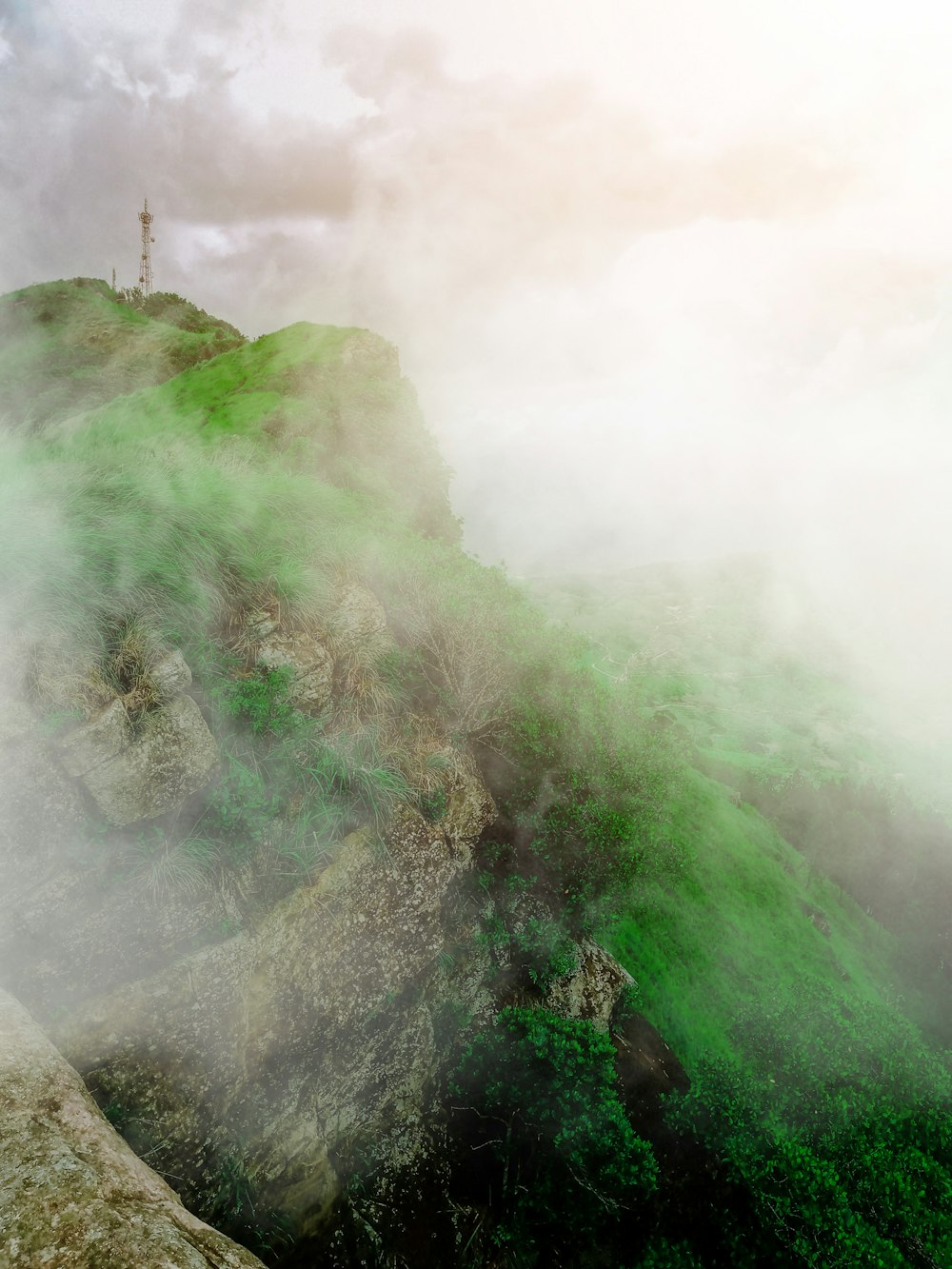 green mountain covered with fog