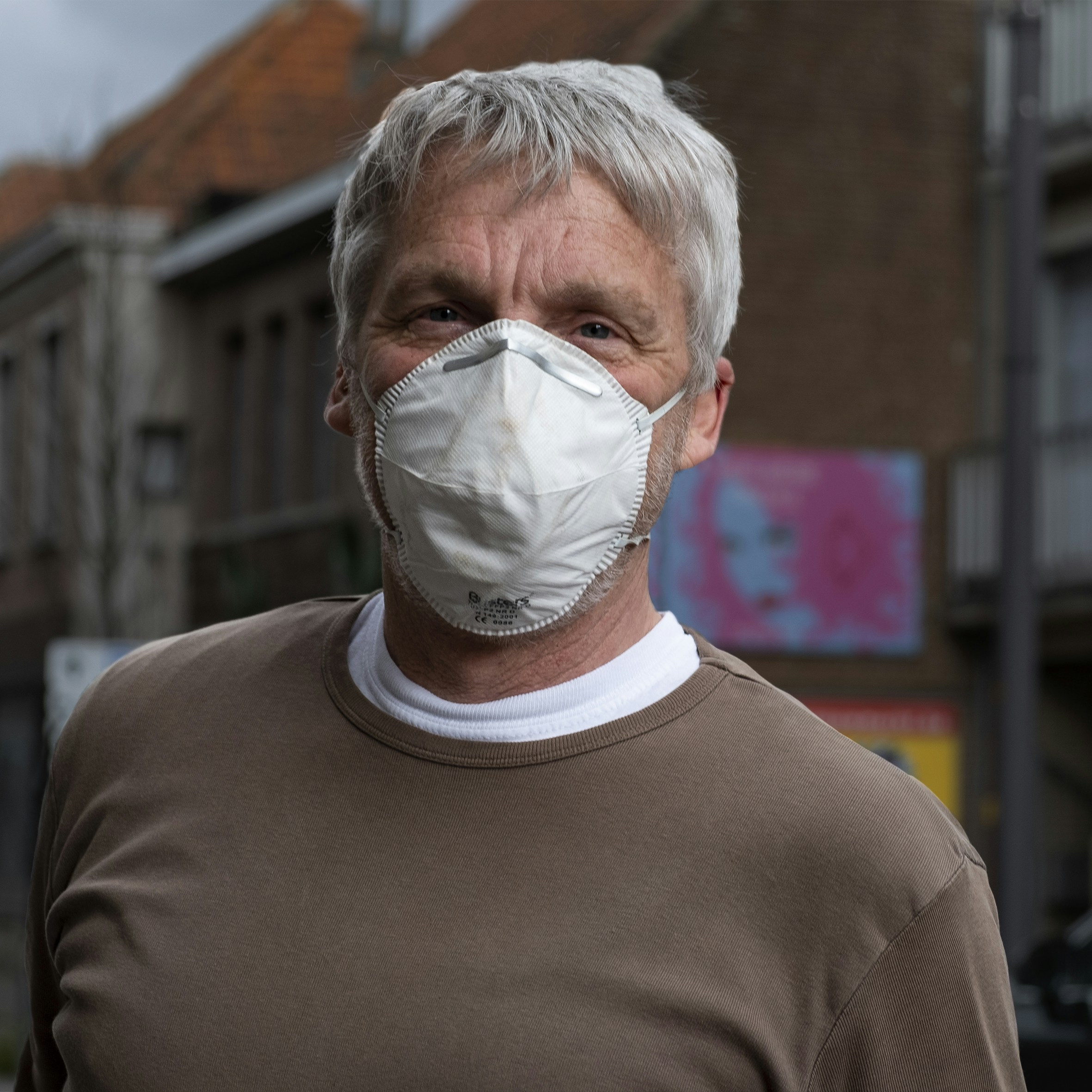 man in gray crew neck shirt with white face mask