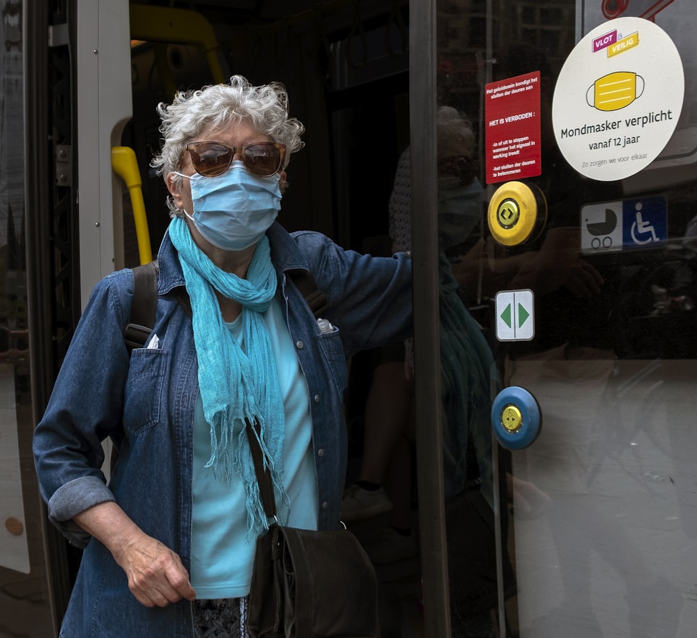 man in blue jacket wearing yellow mask