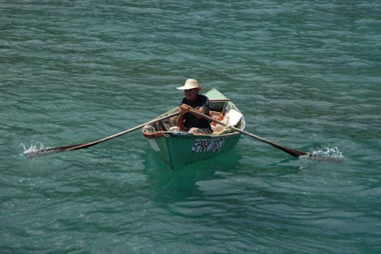 man in white shirt riding on boat during daytime in Ocho Rios Jamaica