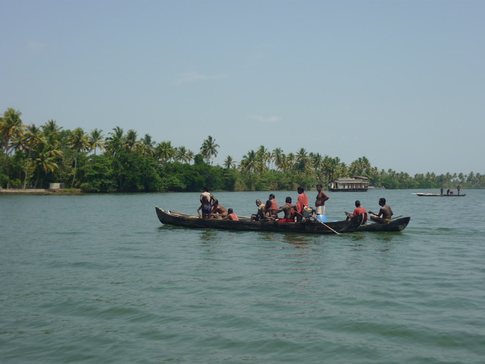 people riding on boat on body of water during daytime