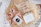 Soft pastel gift box opened to reveal elegant self-care items nestled in cream tissue paper